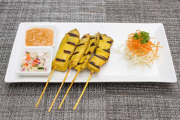 4 Pieces Satay · Grilled tender strips of marinated chicken on skewers, served with a side of peanut sauce and cucumber relish. Mild.