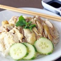 Khao Man Gai · Sliced hainan style with steamed chicken with marinated rice.