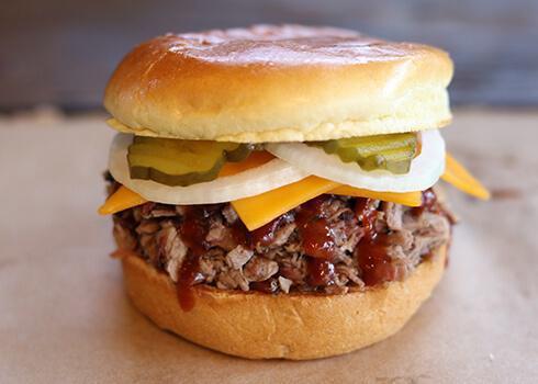 Brisket & Cheese Classic Sandwich · Includes a choice of chopped or sliced delicious slow-smoked brisket, Tillamook cheddar cheese on a Brioche bun