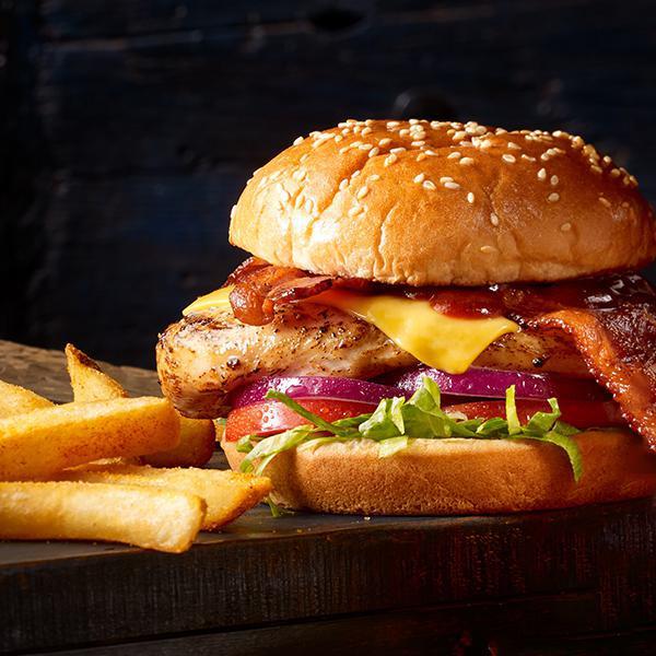 BBQ Bacon Cheddar Burger · Your Choice of Protein, Melted Cheddar Cheese, Smoked Bacon, Shredded Lettuce, Tomatoes, Sweet Red Onions, Sweet Barbecue Sauce, Served on a Brioche Bun with French Fries. Substitute Reduced-gluten Bun or Impossible Burger for an Additional Charge.