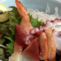 Sunomono Sushi · Crab, conch, octopus, shrimp, cucumbers masago, green onions, sesame seeds, and rice vinegar.