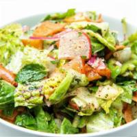 Fattoush Salad · Lettuce, tomatoes, cucumbers, onions, mint pomegranate and pita chips