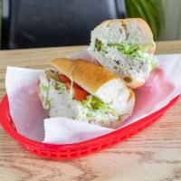 12. Tuna Salad Sandwich · Served with cheese, lettuce and tomato.