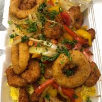 Fried Calamari over yellow Rice · Served over yellow rice with mustard aioli sauce and grilled veggies.