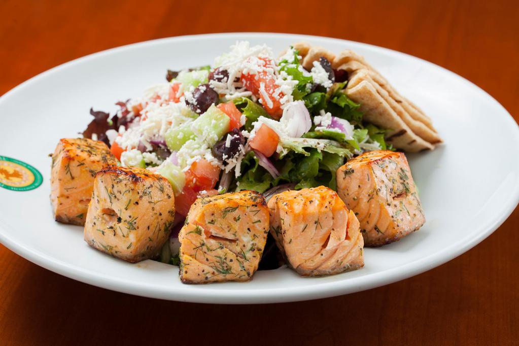 Salmon Salad · Grilled Atlantic salmon on a bed of mixed greens topped with cucumbers, tomatoes, red onions, olives, feta, lemon and balsamic vinaigrette.