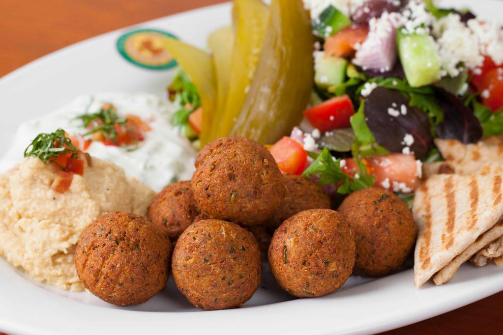 Falafel Platter · Falafel (vegan) made from garbanzo beans and herbs. Served with hummus, tzatziki, pickles and pita bread.