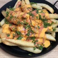 Lime Chipotle Fries · Cheddar cheese, cilantro, lime and chipotle sauce.