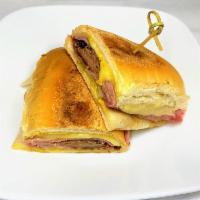 Cuban Sandwich · Homemade roasted pernil, ham, Swiss cheese, pickles and mustard on pressed Cuban bread.