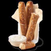 Pretzel Sticks with Zesty Queso · Soft pretzel sticks, served hot from the oven, topped with salt, and served with warm zesty ...
