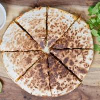 Lusy's Mediterranean Quesadilla · Toasted pita topped with fresh Greek feta, mozzarella cheese and herbs. Add chicken for an a...
