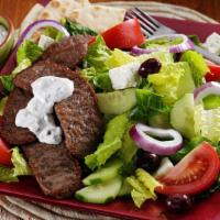 Gyros Plate · Generous slices of grilled beef gyros with pita bread, tzatziki sauce and chopped tomato.