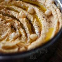 Side Hummus · Simmered until tender garbanzo beans pureed with sour cream, garlic, tahini sauce and season...