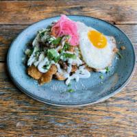 Chilaquiles · house made tortilla chips, salsa roja, sour cream, cotija cheese, citrus pickled onion, jala...