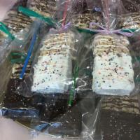 Chocolate Dipped Rice Crispie Squares on a Stick · Rice Crispie cereal treat dipped in either white or milk chocolate with sprinkles on a stick!