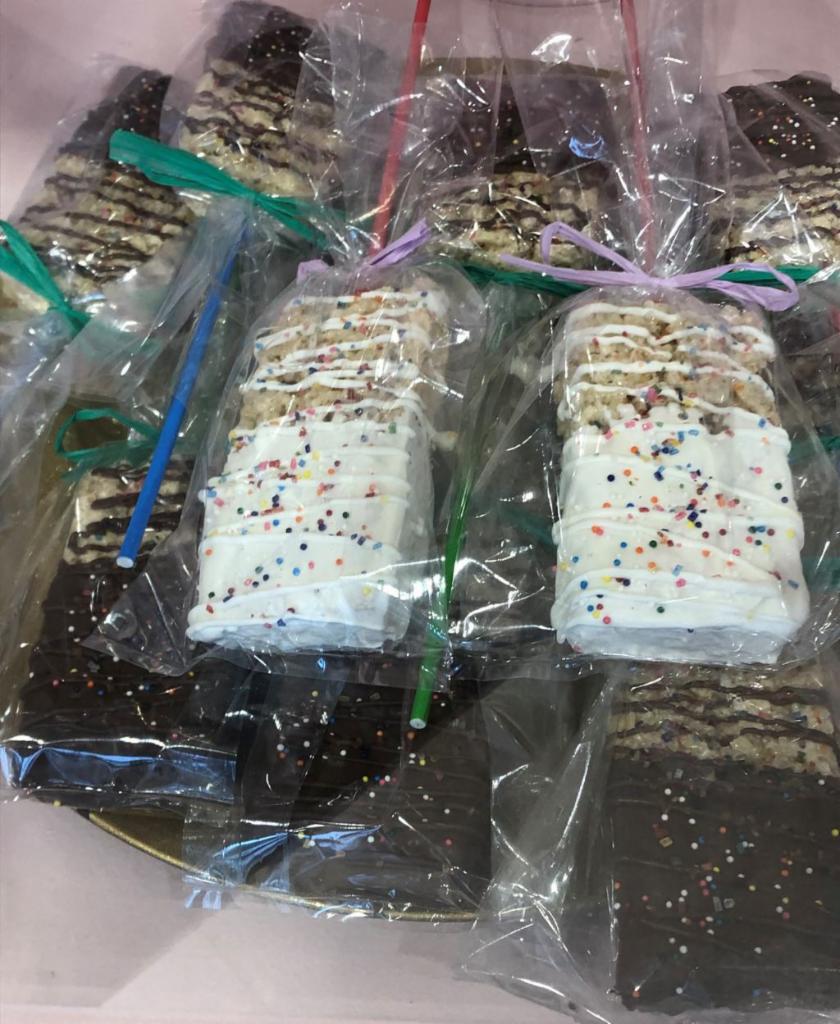 Chocolate Dipped Rice Crispie Squares on a Stick · Rice Crispie cereal treat dipped in either white or milk chocolate with sprinkles on a stick!
