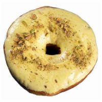 Lemon Pistachio · Large yeast donut dipped in lemon glaze and dusted with crushed pistachios