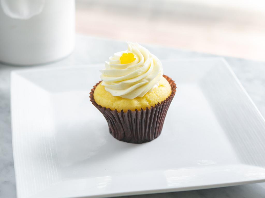 Lemon Cupcake · Vanilla cake filled with tangy lemon topped with our lemon buttercream and a dollop of tangy lemon.