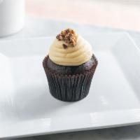 Peanut Buttercup Cupcake · Chocolate cake with peanut butter cream cheese frosting topped with crumbled peanut butter c...