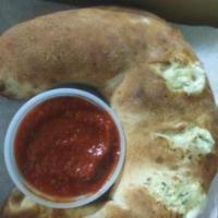 Calzone · Filled with ricotta and mozzarella cheese, side of marinara.