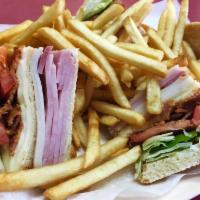 Club Sandwich with Fries · Ham, turkey, cheese, bacon, lettuce, tomatoes, mayonnaise and french fries.