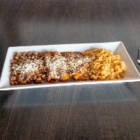 Chicken Enchiladas · two chicken enchiladas topped with cotija cheese, served with rice & beans
