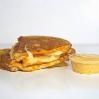 Three Cheese Grilled Cheese · Cheddar, Swiss, and Parmesan cheese melted between buttery, toasted sourdough bread. Served ...