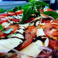 Caprese Salad · Sliced tomato, fresh mozzarella and basil topped with balsamic reduction.