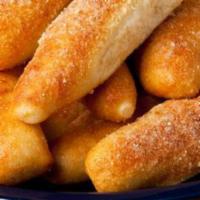 Breadsticks · 6 breadsticks golden and fluffy, coated in garlic butter, and Parmesan served with ranch. Ve...