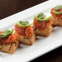 CRISPY SPICY TUNA* · Spicy tuna mix served on top of crispy sesame rice; drizzled with black pepper soy sauce; to...