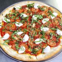 Margherita Pizza · Fresh mozzarella, fresh sliced tomatoes, tomato sauce and basil leaves.