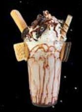 Cookie and Cream Milk Shake · Chocolate rim with cookie pieces, chocolate sprinkles, chocolate chips, topped with Oreo coo...
