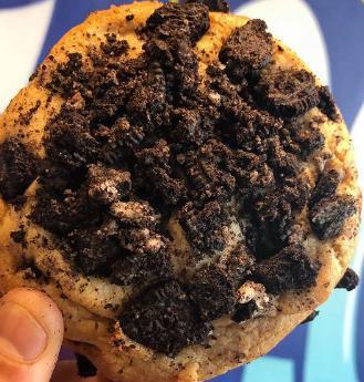 Vegan Cookie and Cream Cookie · Vegan cookie dough, mixed with vegan chocolate chips, stuffed with an oreo, and topped with more crushed Oreos.