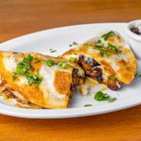 QUESADILLA GRINGA · Delicious flour tortilla filled with our
exquisite meat al pastor and cheese