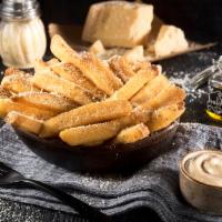 Double Truffle Fries · Potato fries tossed in truffle oil and topped with Parmesan cheese. Served with truffle aiol...