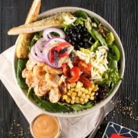 Southwest Chicken Salad · Grilled spiced chicken sits atop a bed of fresh mixed greens and a savory blend of red onion...