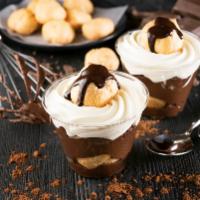 Profiterole · Cream puff pastry covered in rich chocolate and topped off with whipped cream.