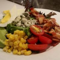 Cobb Salad · Fresh mixed mesclun greens topped with bleu cheese, avocado, fresh shaved corn, grape tomato...
