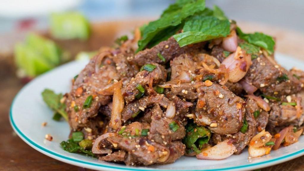 Nam Tok ( Thai Beef salad ) · Beef tenderloin with greenleaf lettuce, green onion, baby spinach, tomatoes, cucumbers, cilantro, Thai chilies, toasted-ground rice and a spicy Thai dressing.