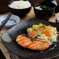 Salmon Teriyaki · Grilled salmon in a seasoned teriyaki sauce, served with jasmine rice and a mixed-green sala...