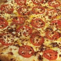 White Cheezy Pizza · Bacon, onions, sliced tomatoes, feta cheese, our signature three cheeses, all on our garlic ...