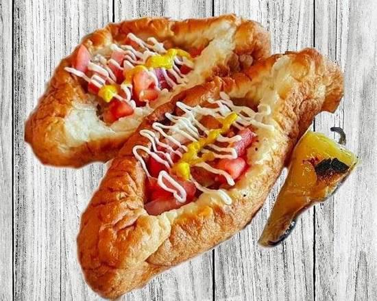 Sonoran Dog (100%BEEF HOT DOG) · Bacon it's like HIGH-FIVE to your mouth! Beef dog Wrapped in bacon, whole pinto beans, grilled onions, tomato, mayonnaise, mustard, jalapeno sauce. All in a  bolillo-style hot dog bun.