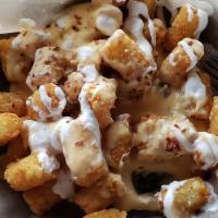 Loaded Tots · Served with cheese, bacon, and sour cream.