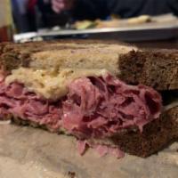 Corned Beef Reuben Sandwich · On your choice of thick cut White, Wheat, Marble Rye or Gluten Free Roll. Corned beef, sauer...