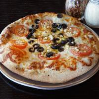 20. The Greek Pizza · Cheese, olive oil base, spinach, sliced tomatoes, black olives, feta, and fresh garlic.