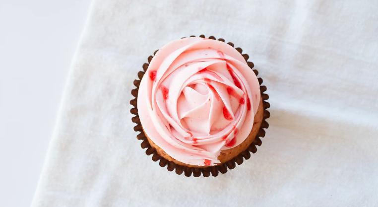 Strawberry Cupcake · Strawberry cake with our signature strawberry buttercream and fresh sliced strawberry.