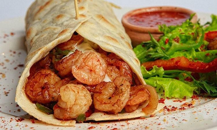 Shrimp Burrito · Shrimp, rice, bell pepper, onion, cilantro, tomatoes and lettuce.