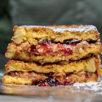 PB+J Cornflake French Toast · classic pb+j sandwich with grape jelly, dipped in french toast batter, crusted in cornflakes...
