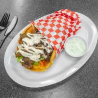 Gyro Beef Sandwich · Gyro meat with tomato, tzatziki sauce, yogurt, lettuce, and onion, rolled in pita bread.