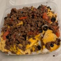 Super Nachos · Nacho chips topped with nacho cheese, tomato, onion, and black olives, served with salsa and...