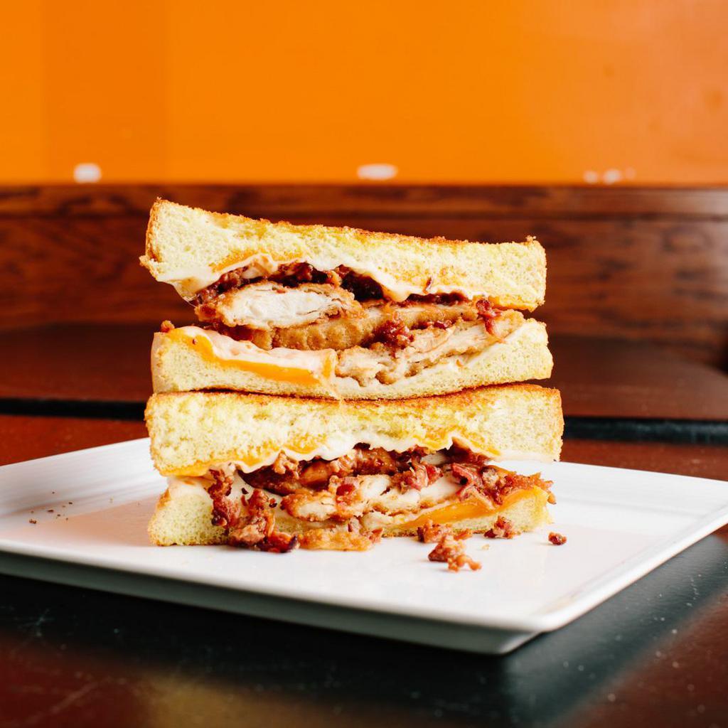 The Tenderizer · Cheddar cheese, mozzarella cheese, bacon, fried chicken tenders, and our special Tendy sauce on Texas toast. Served with a side of ranch dressing. Contains gluten, peanuts, dairy, soy, and nightshades. We cannot make substitutions.